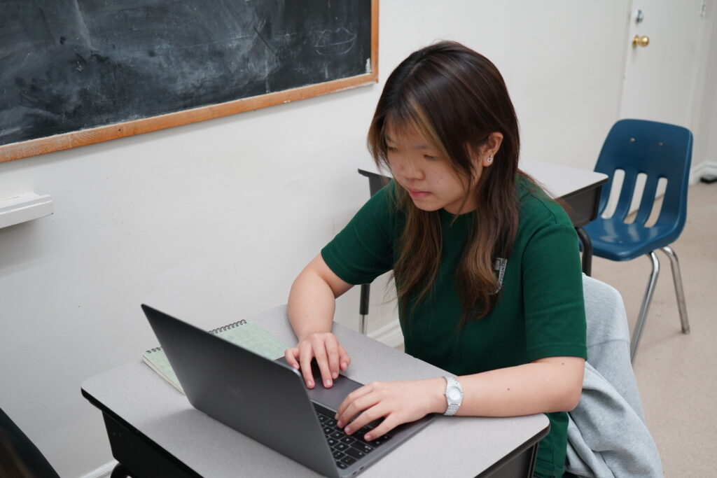GLCT ESL student studying attentively during classroom learning.