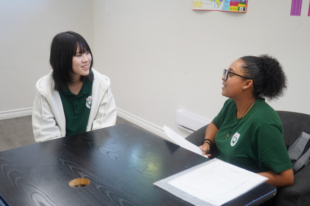 Students from different cultures helping each other in a Canadian high school.