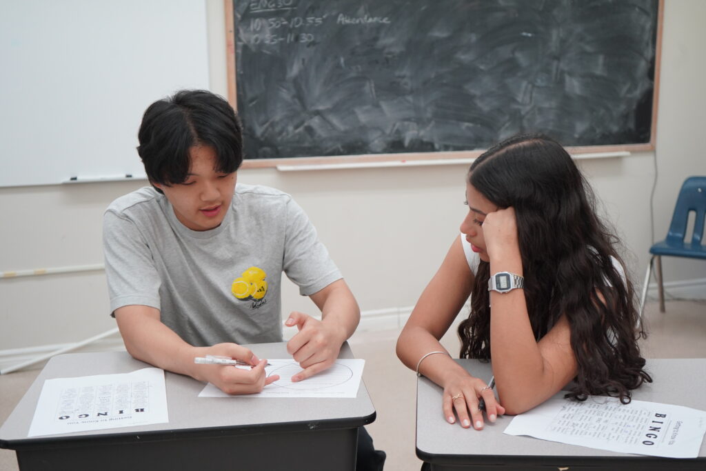 Two international students from diverse backgrounds studying together.